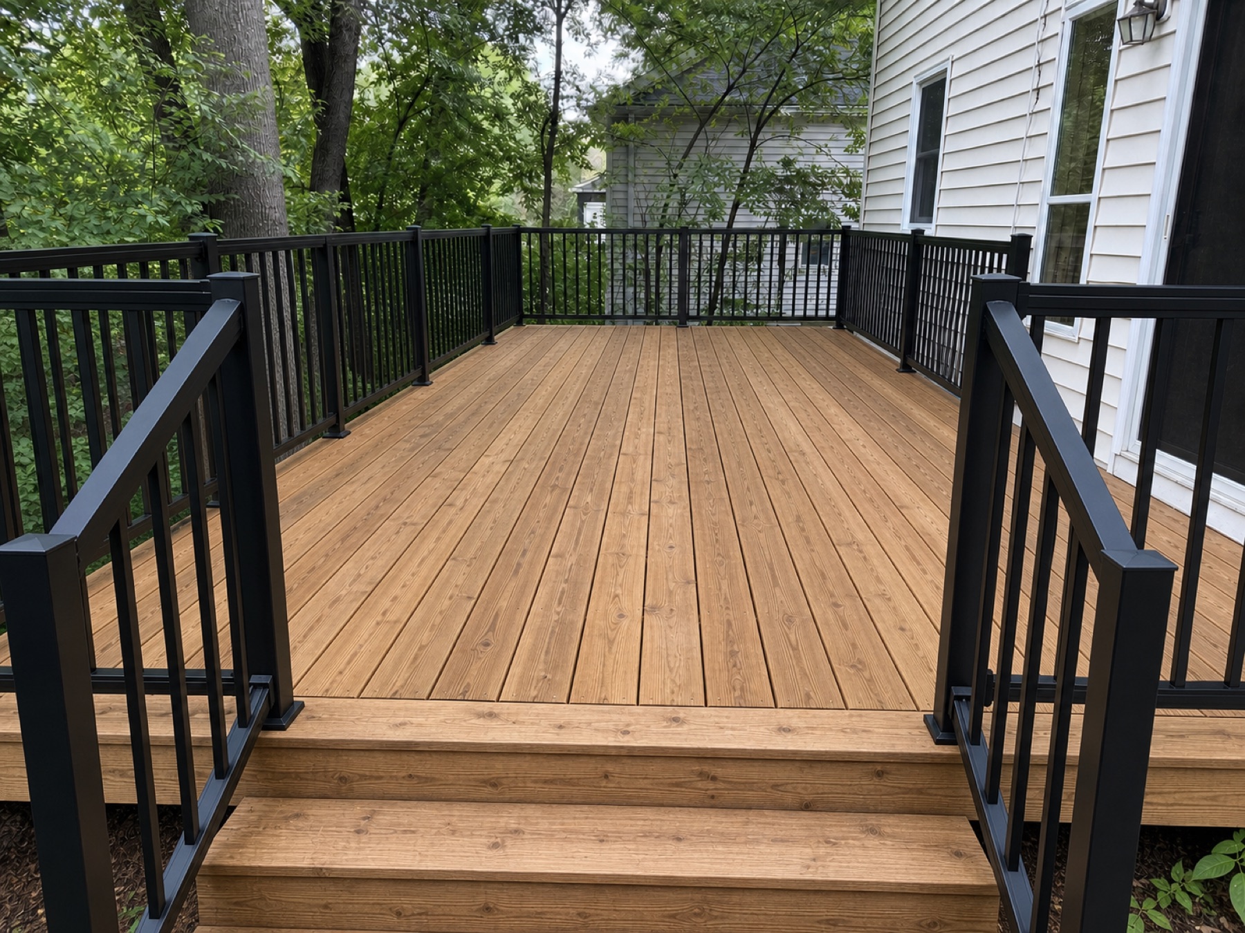 Same deck after treatment, power washing, and railing refresh