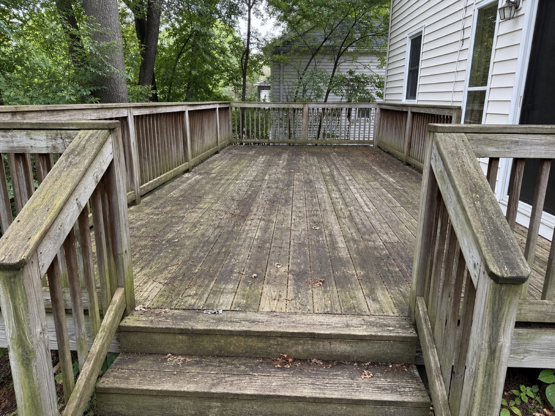 Weathered deck with years of dirt and green surface growth
