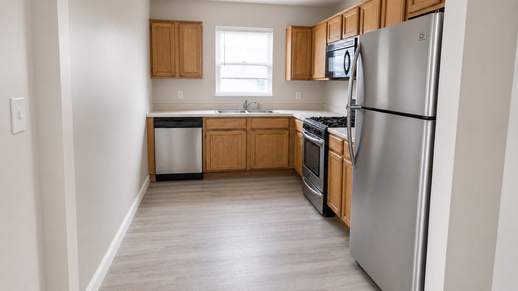 Same kitchen after cleaning, repairs, paint, and preparation work